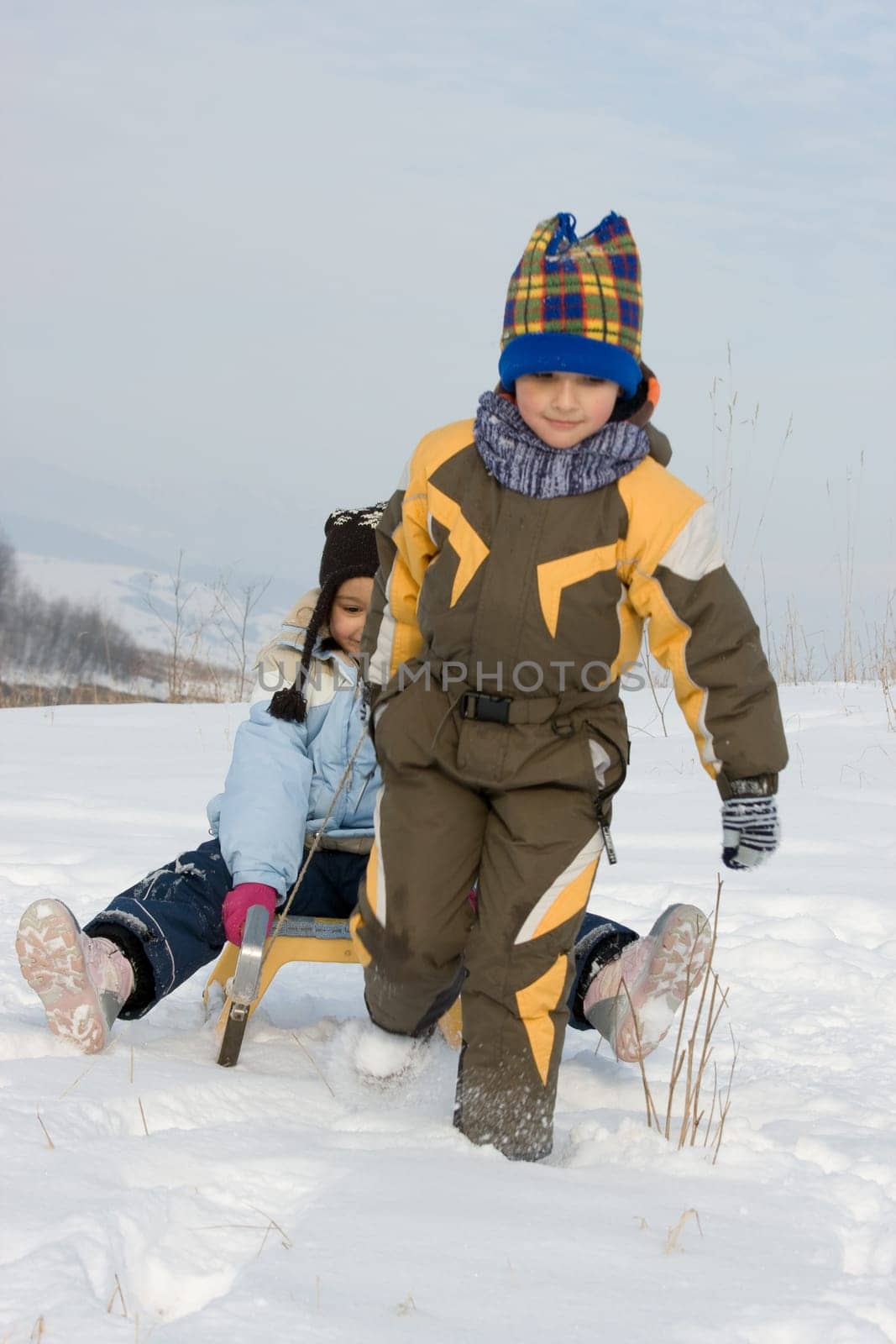 Running boy with sleihg