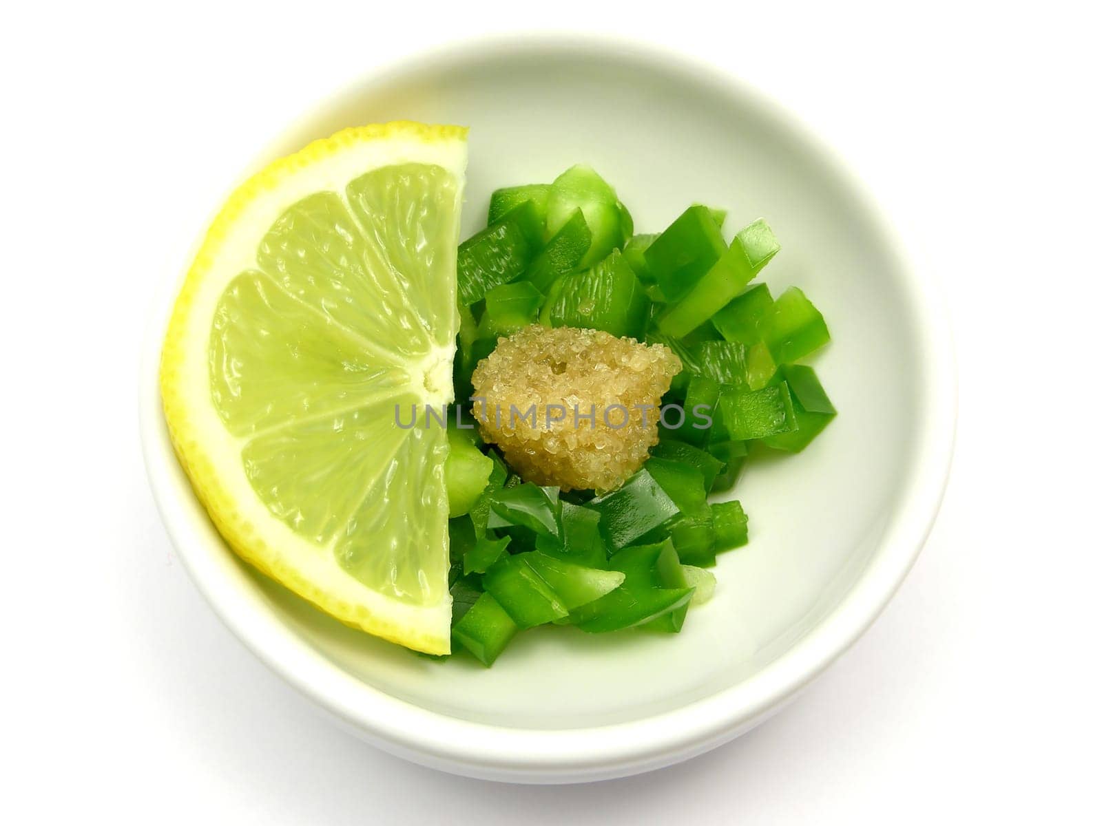 Green bell pepper pieces with sugar and lemon in porcelain bowls