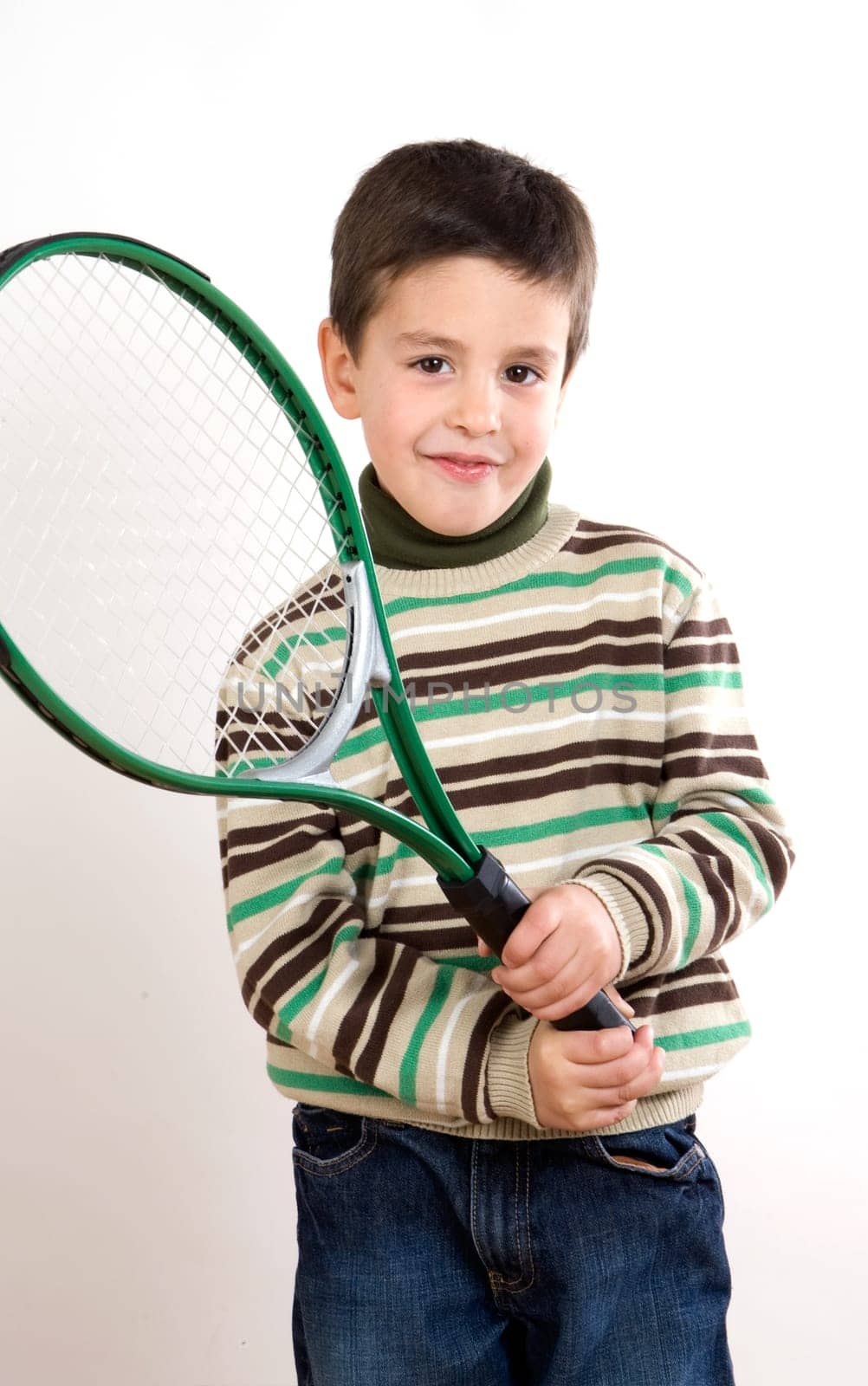 Adorable boy with racket of tennis