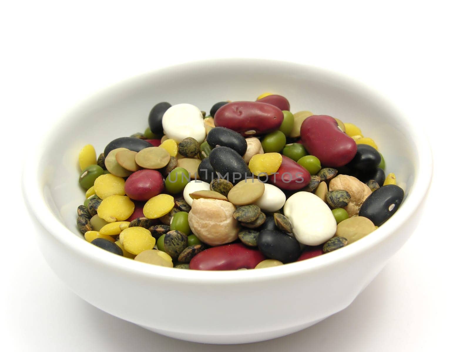Mixed colorful legumes in porcelain bowl