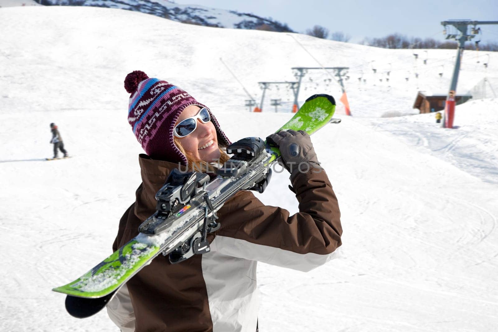 woman carrying skis