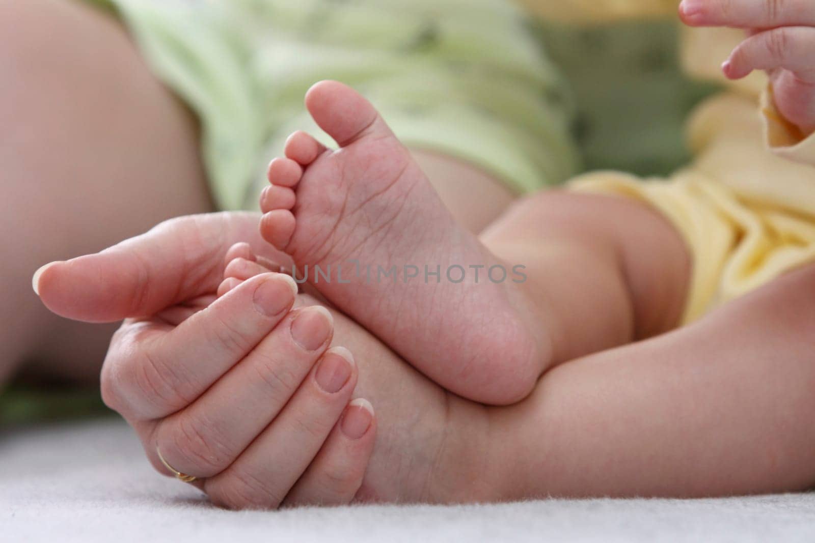 Mother holding her childs feet