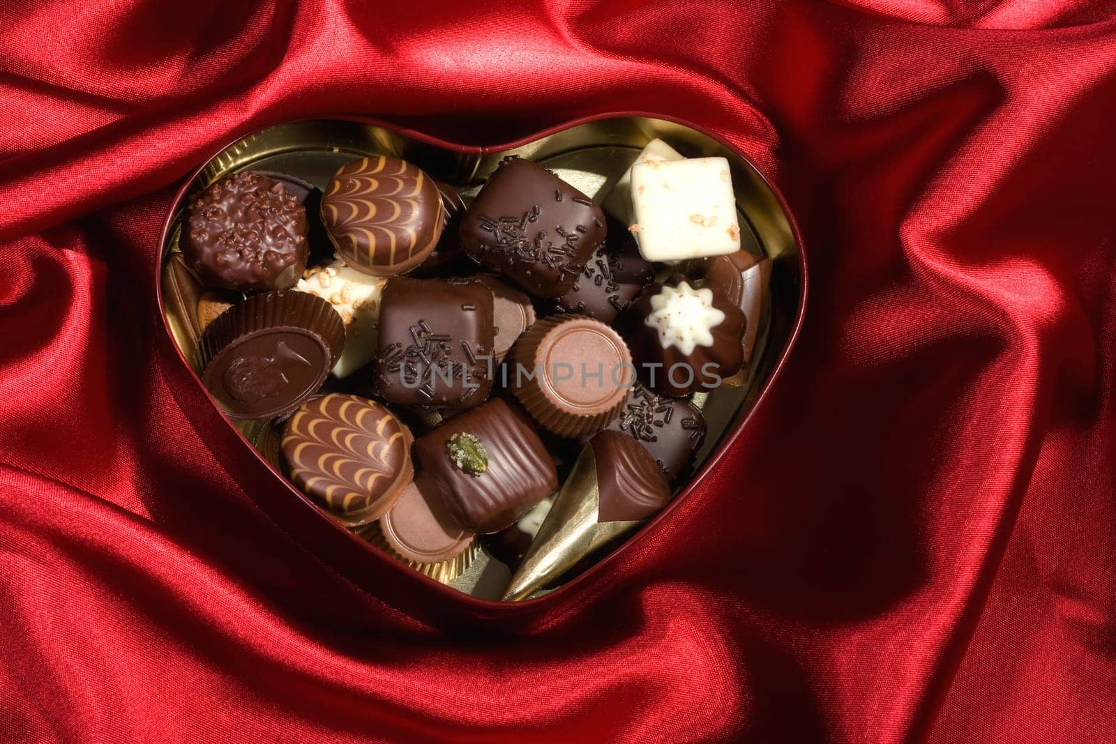 Heart Shaped Box of Candy on red satin