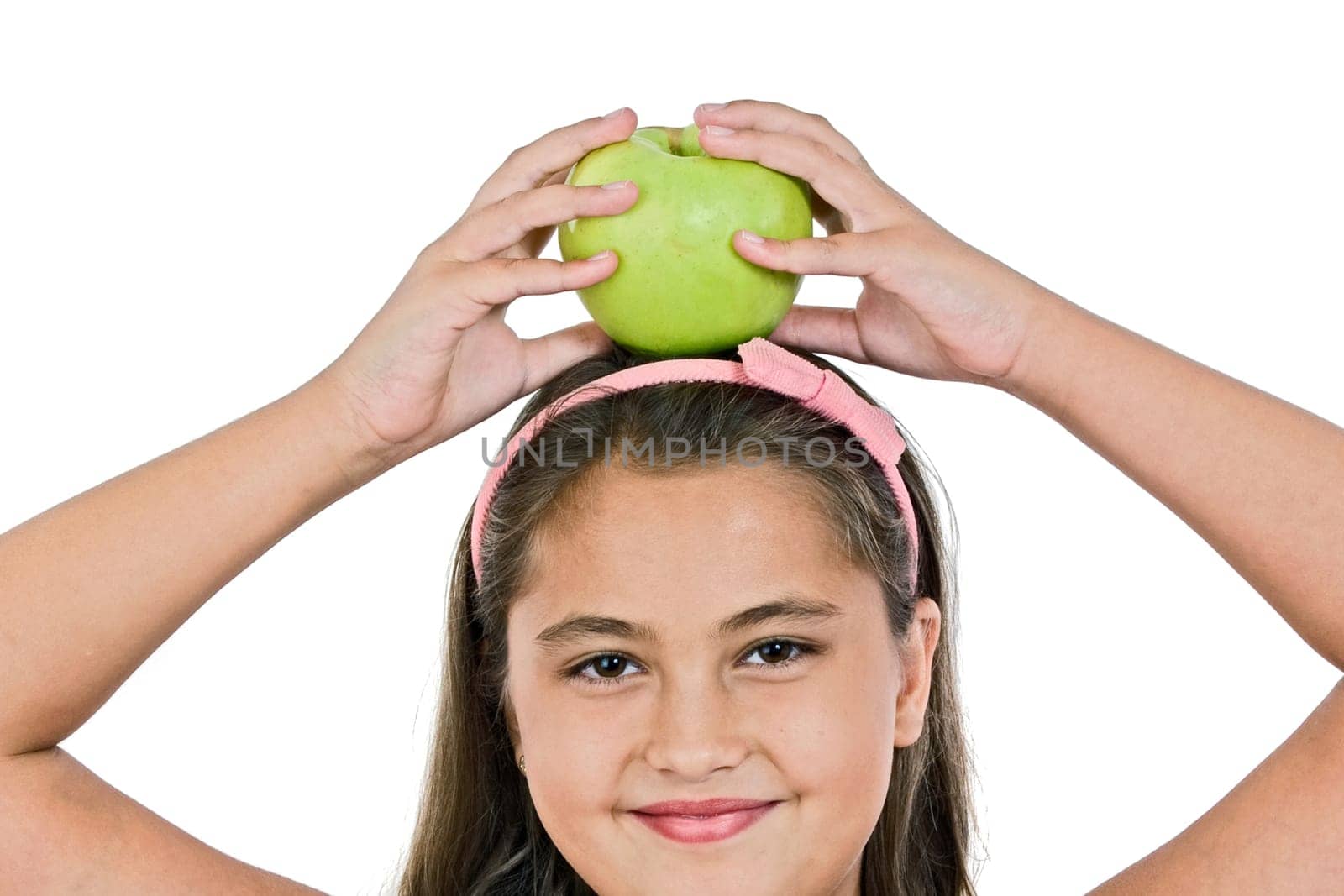 Adorable girl with a apple on her head