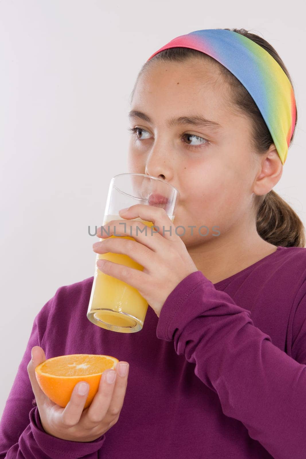 Girl drinking a juice of orange