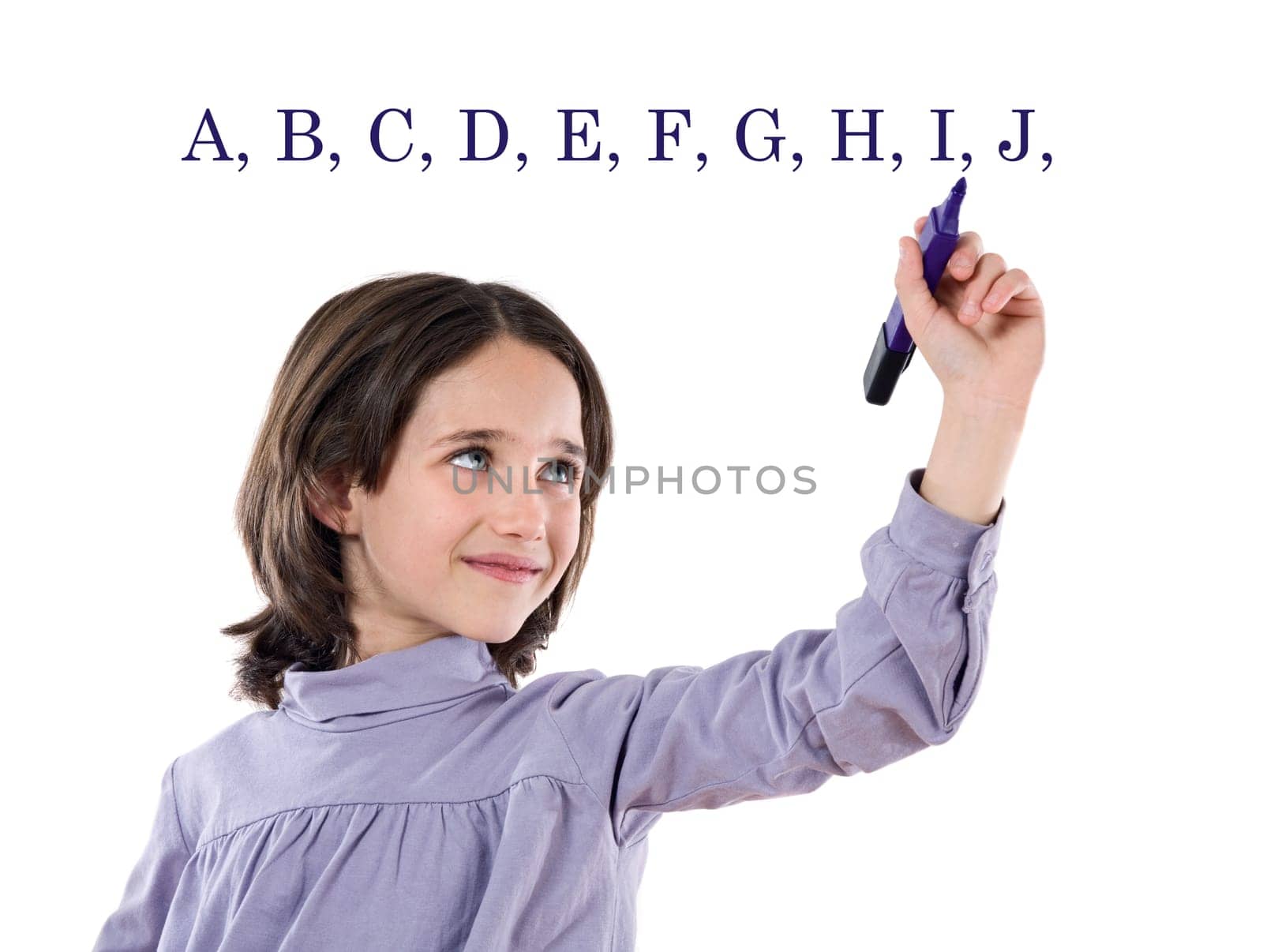 Adorable girl writing the ABC
