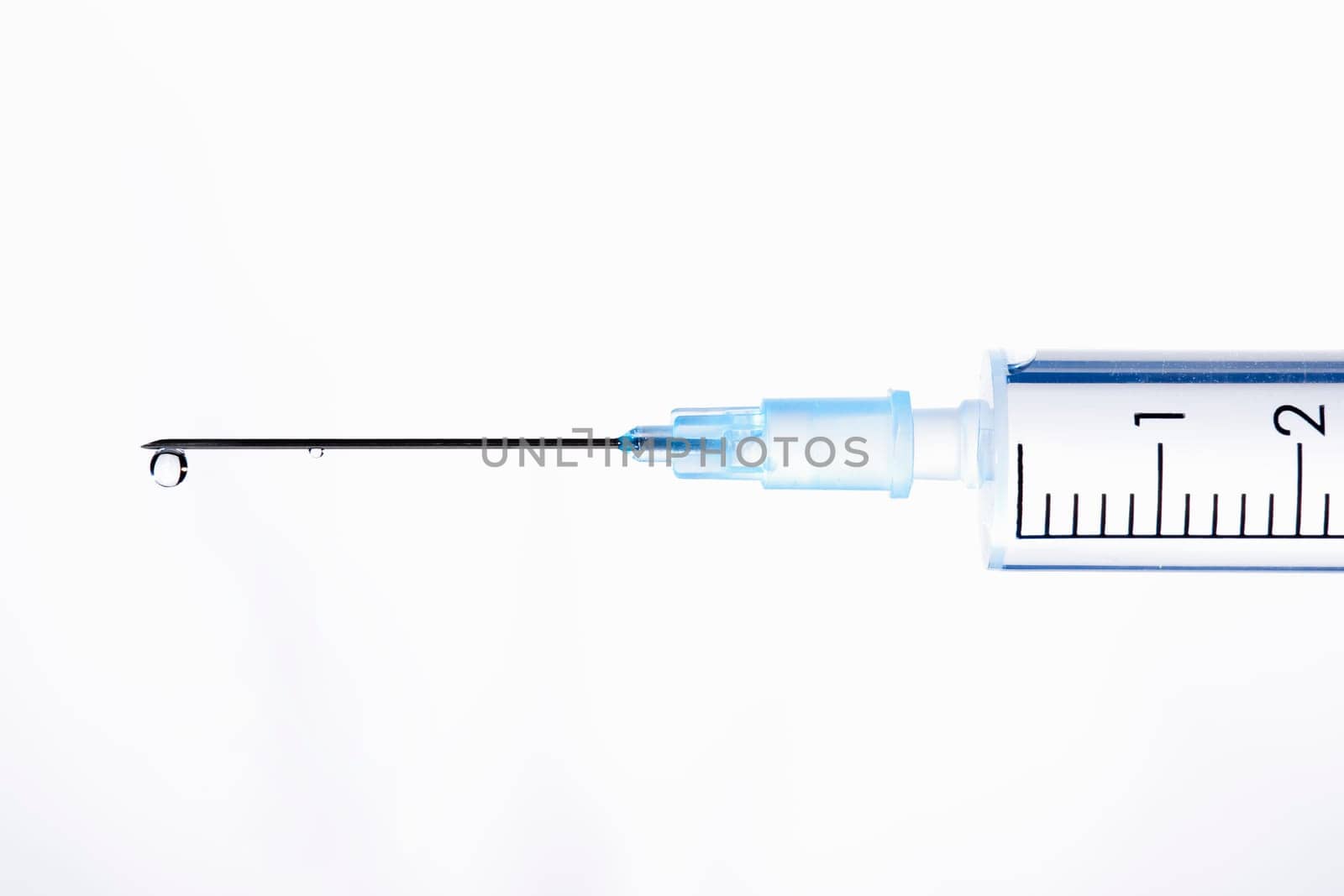 Drop of a liquid on a needle of syringe