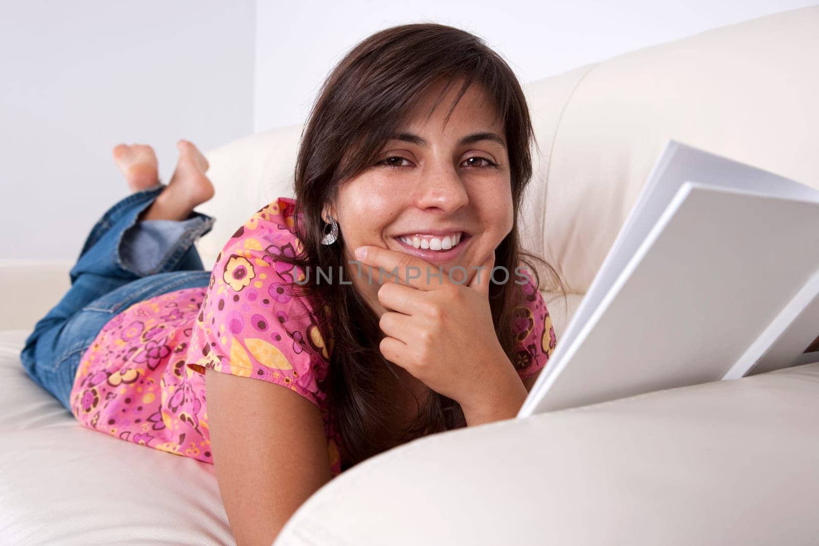young woman reading book in sofa