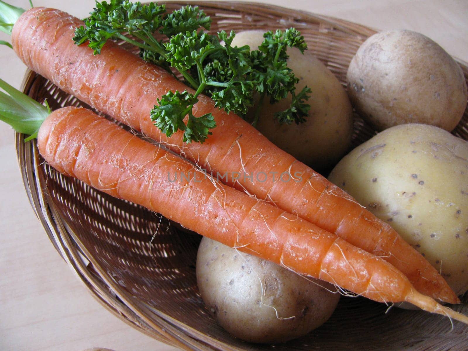 Potatoes and carrots in basket