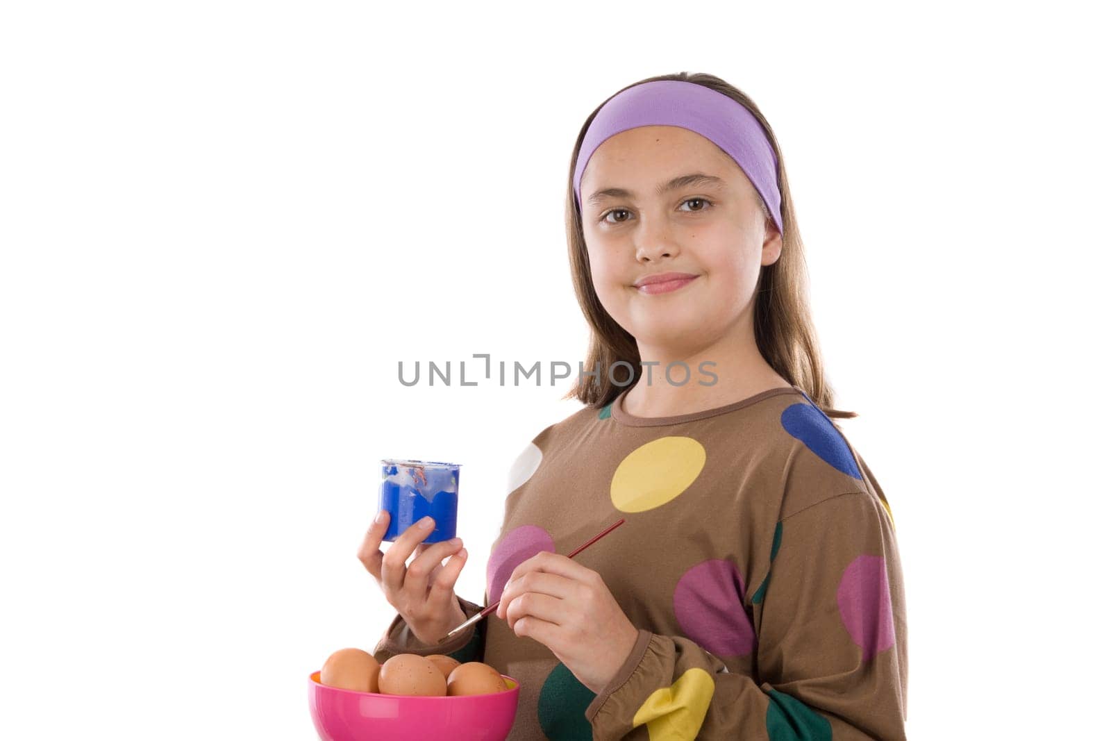 Adorable girl adorning Easter eggs