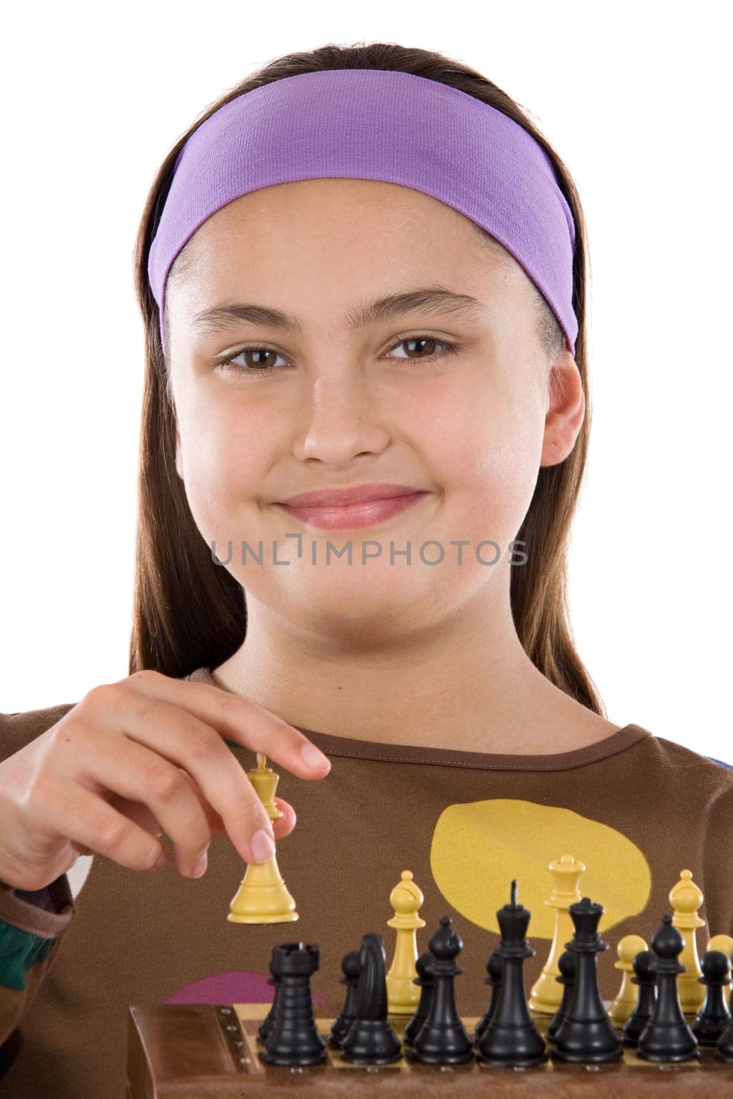 Attractive little girl playing chess