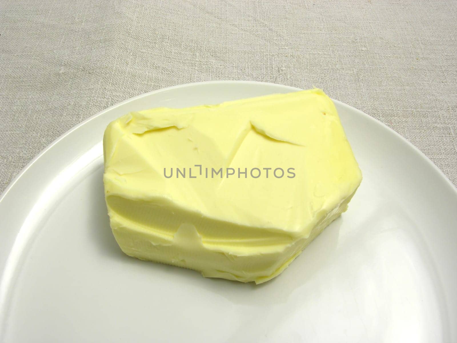 A knob of butter placed on a round plate