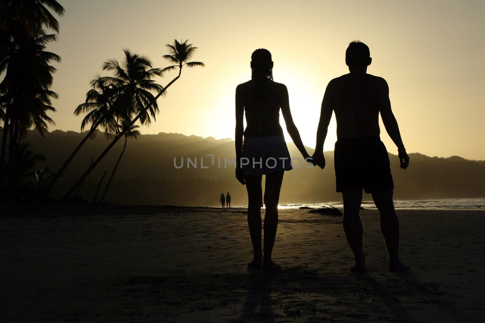 Couple in love on the beach at sunset