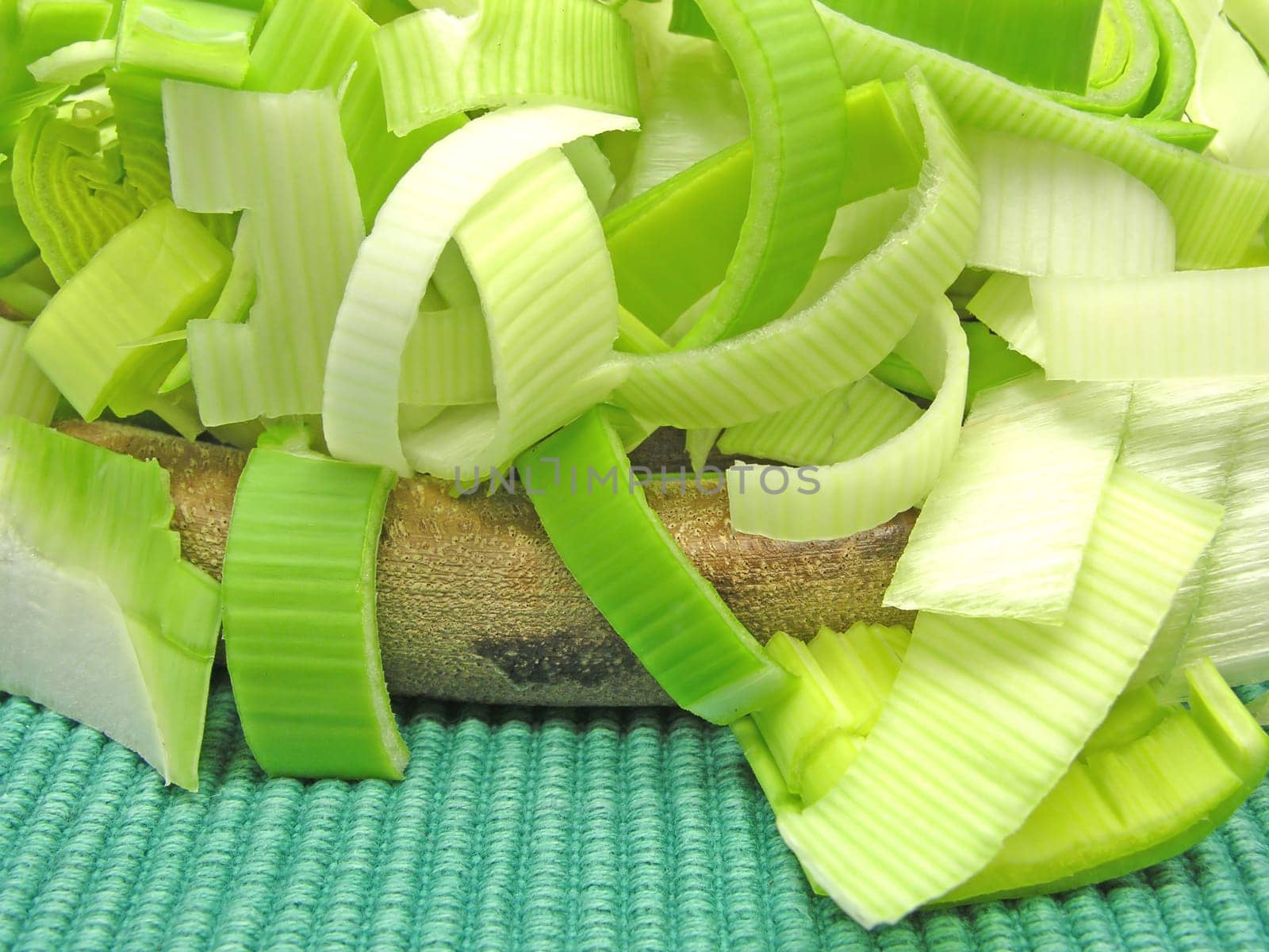 Leeks in slices on wooden board