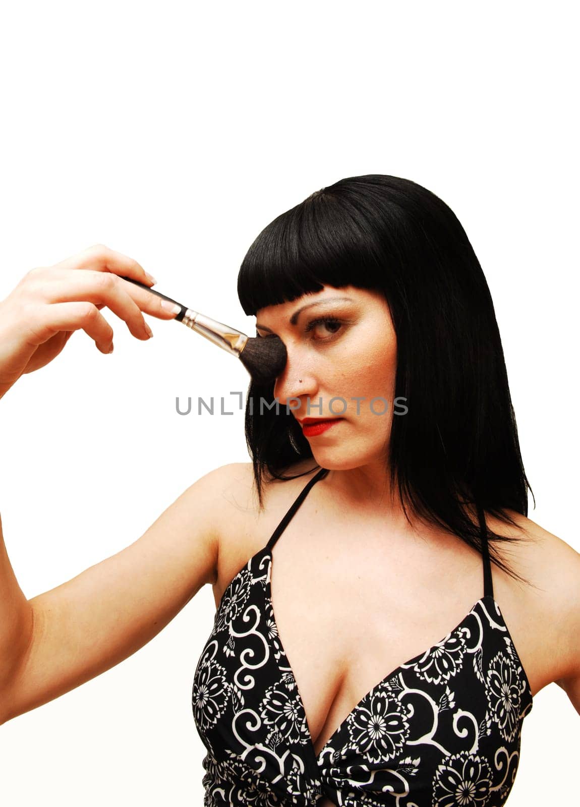 Young woman putting make-up on.