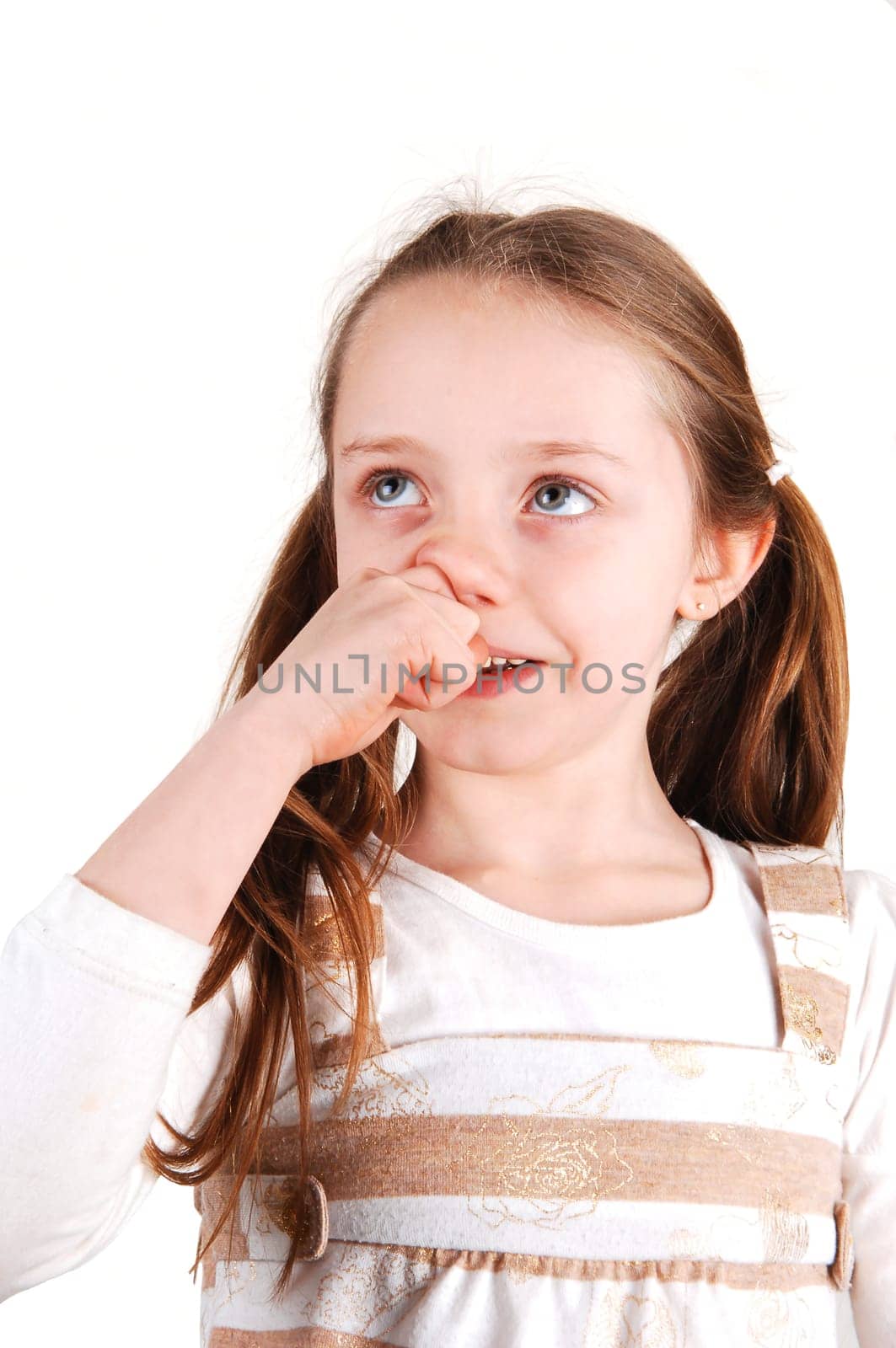 Little girl with finger in nose.