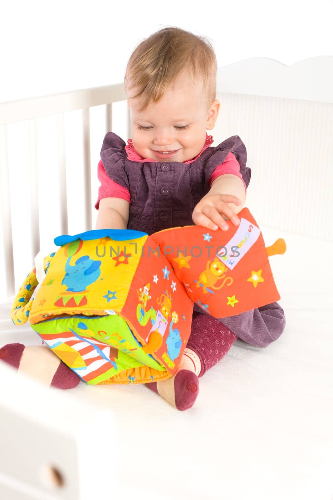 Baby playing with soft toy