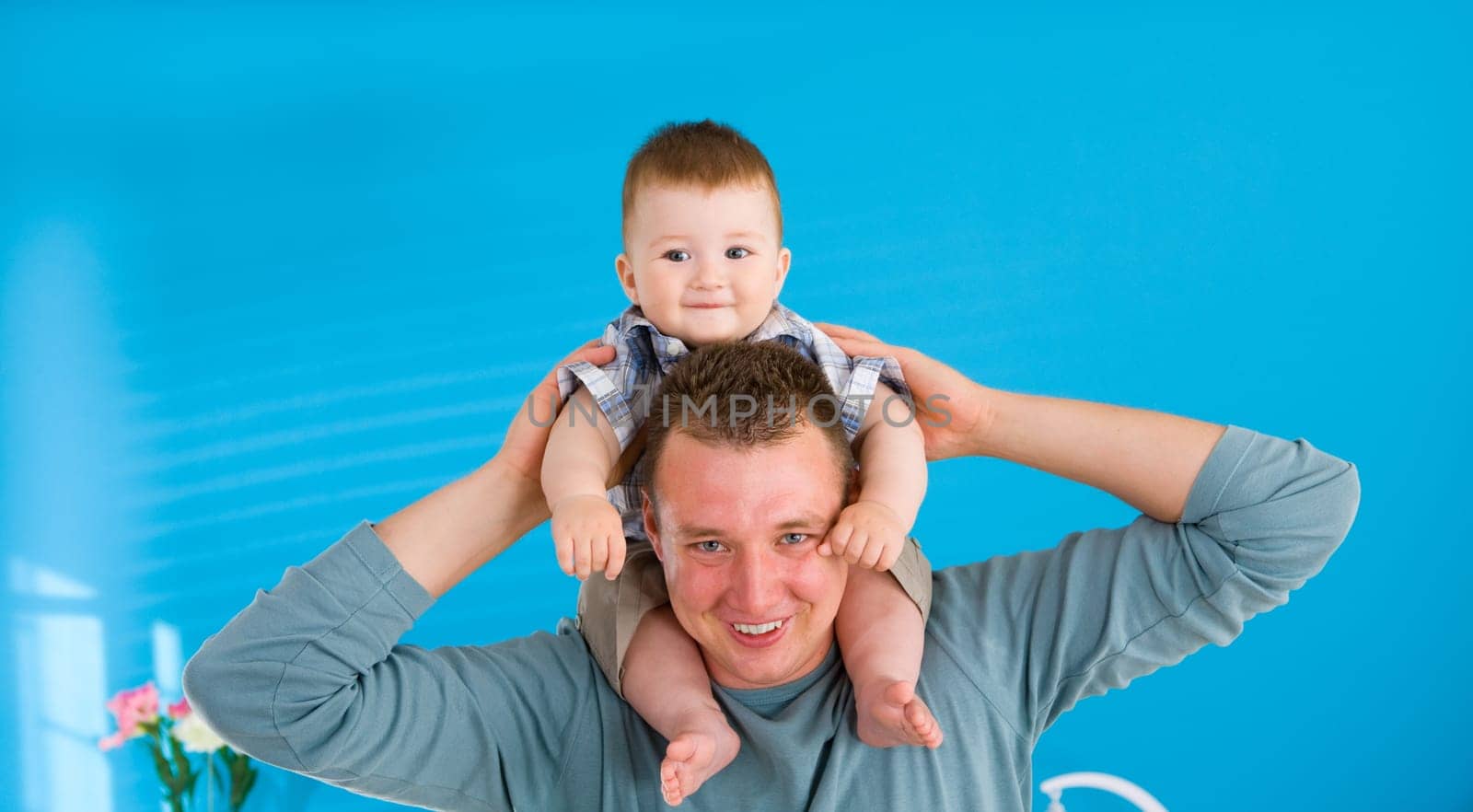 Father lifting happy baby