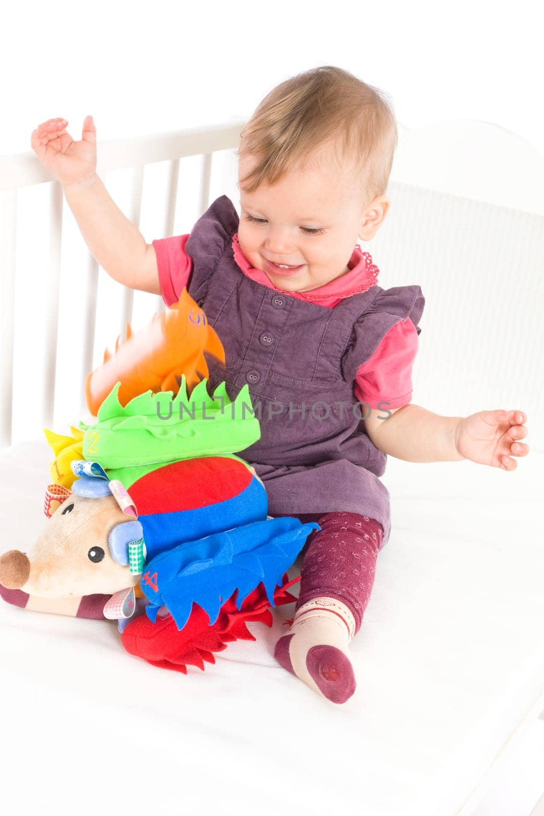 Baby playing with soft toy