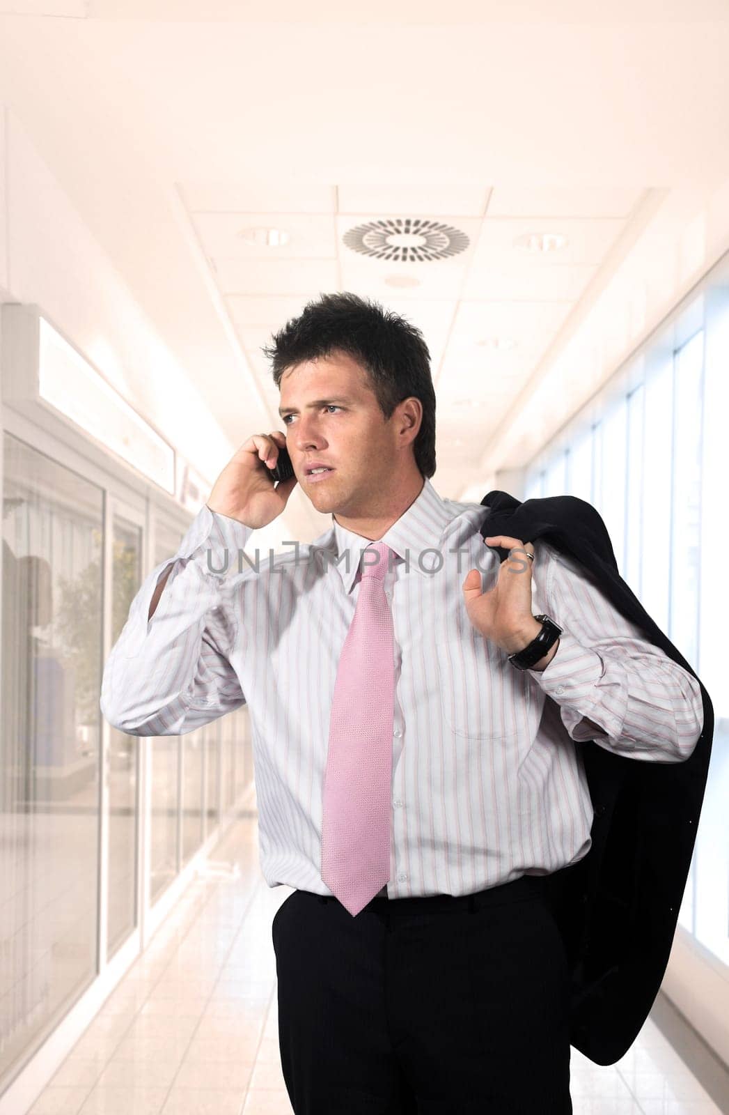 Young businessman is calling on mobile.