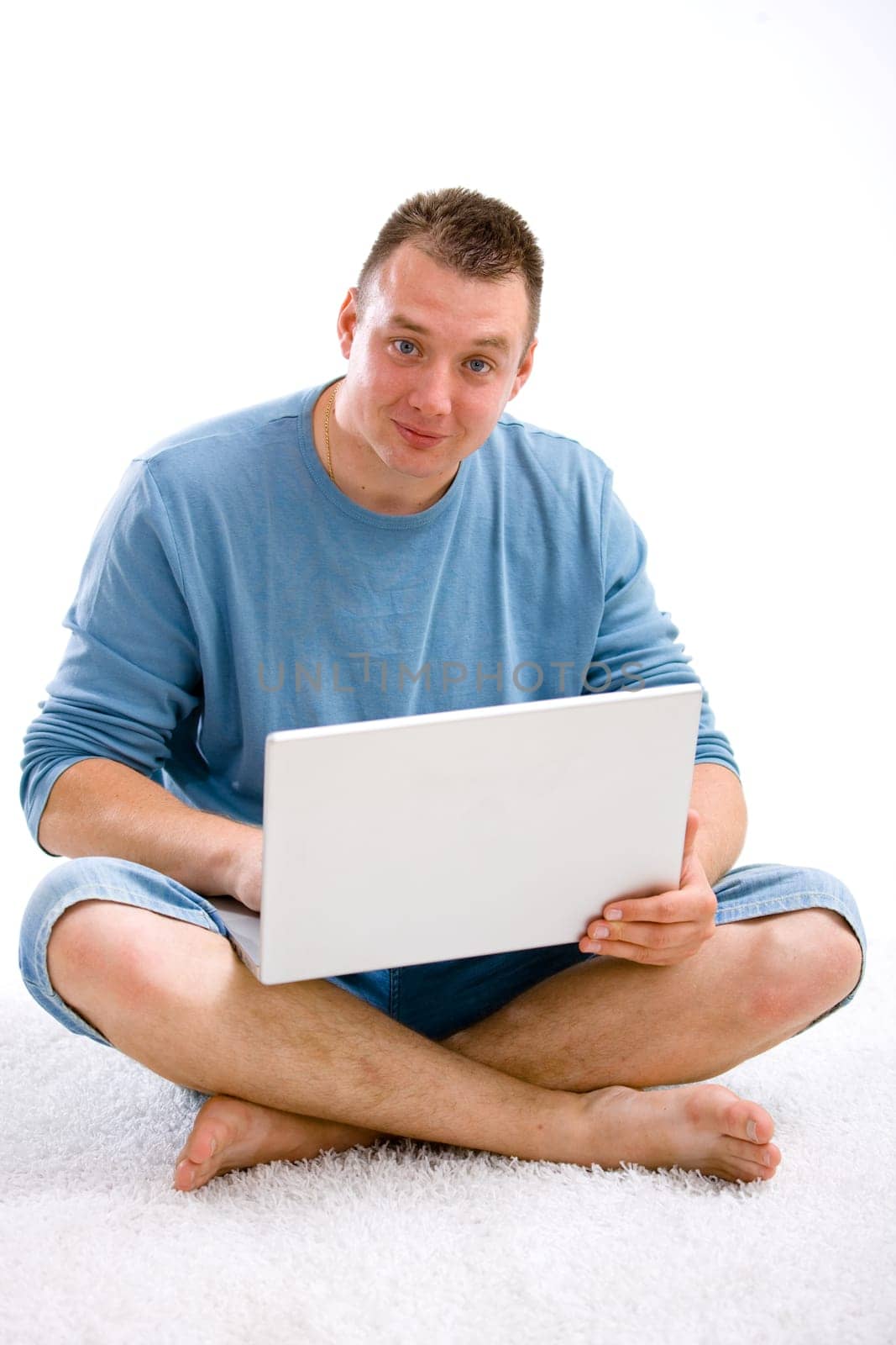 Young casual man with laptop