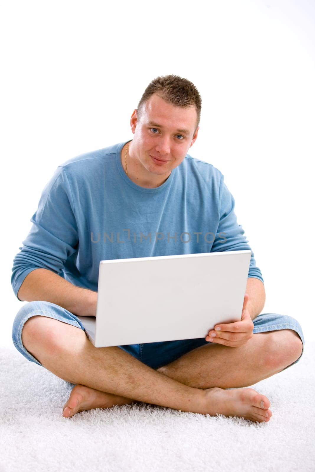 Young casual man with laptop
