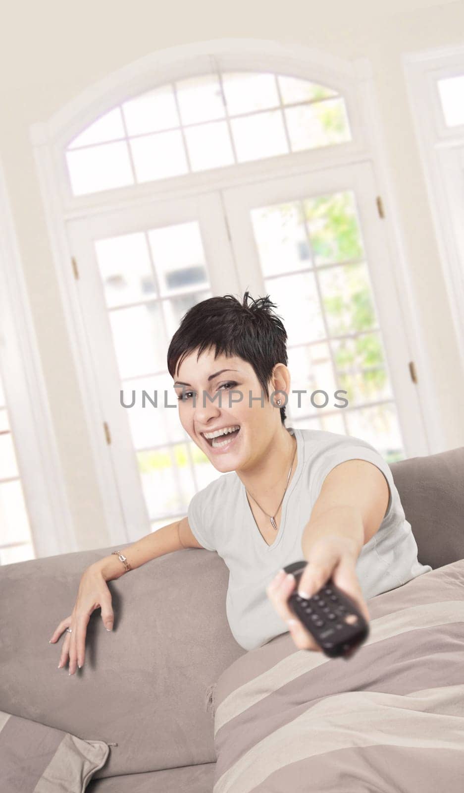 Young woman with TV remote