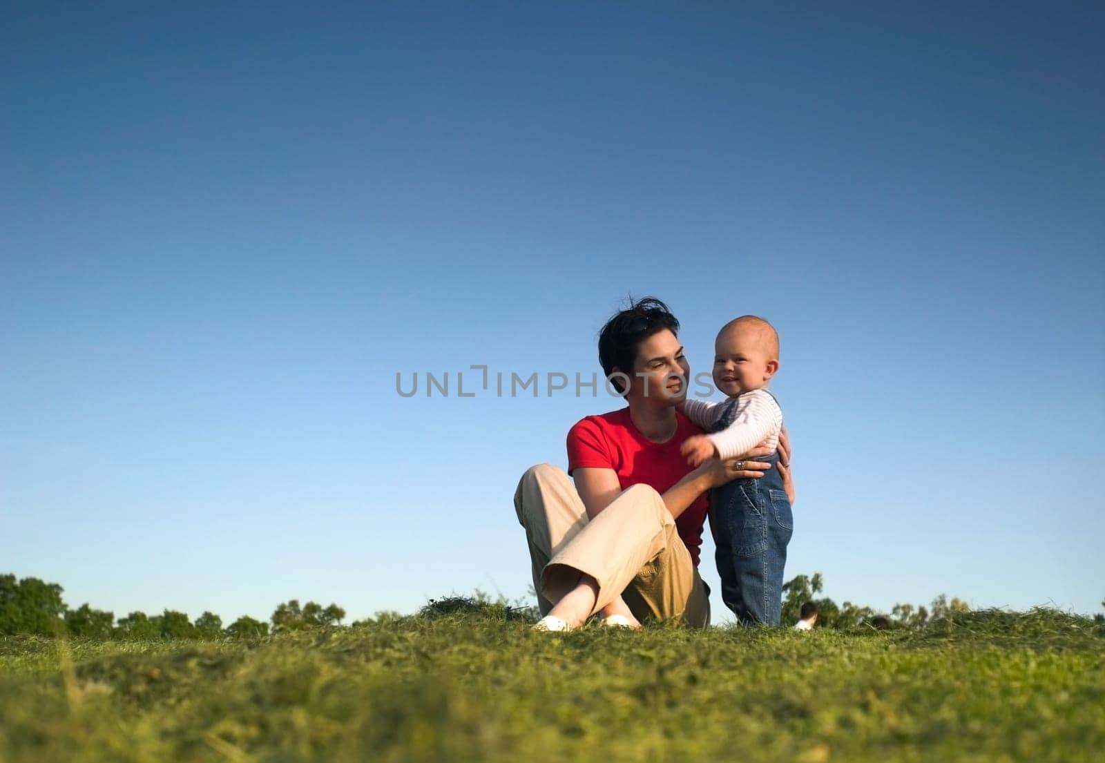 Baby, mother, grass and sky
