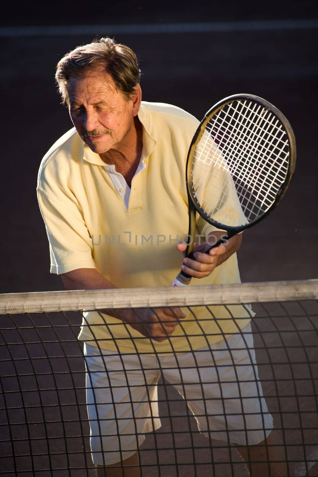 Senior man playing tennis