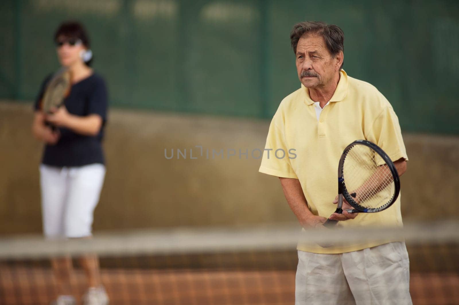 Senior man plays tennis