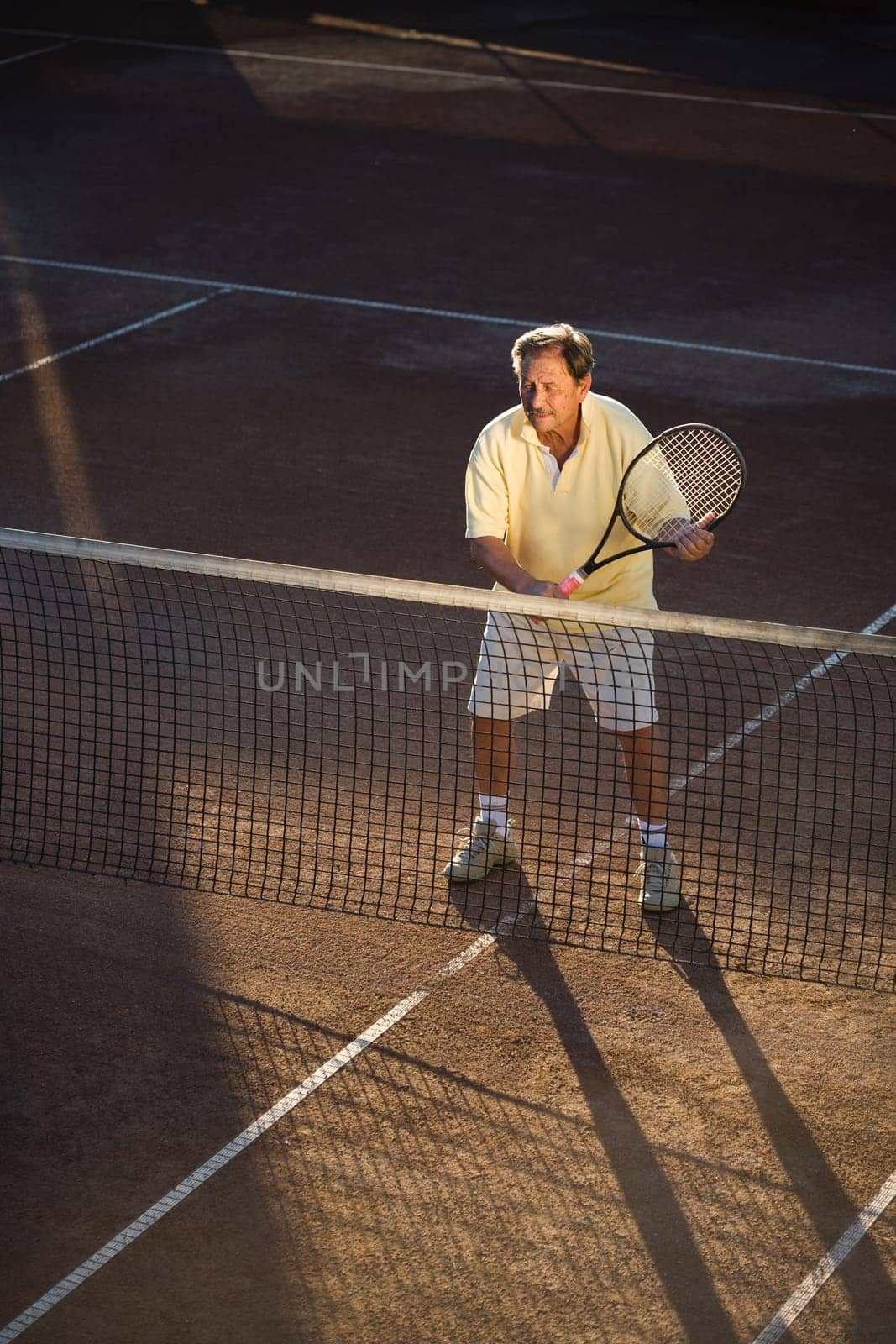 Senior man playing tennis