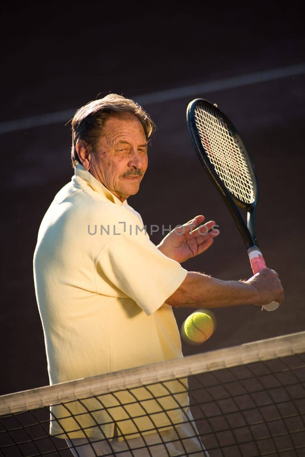Senior man playing tennis