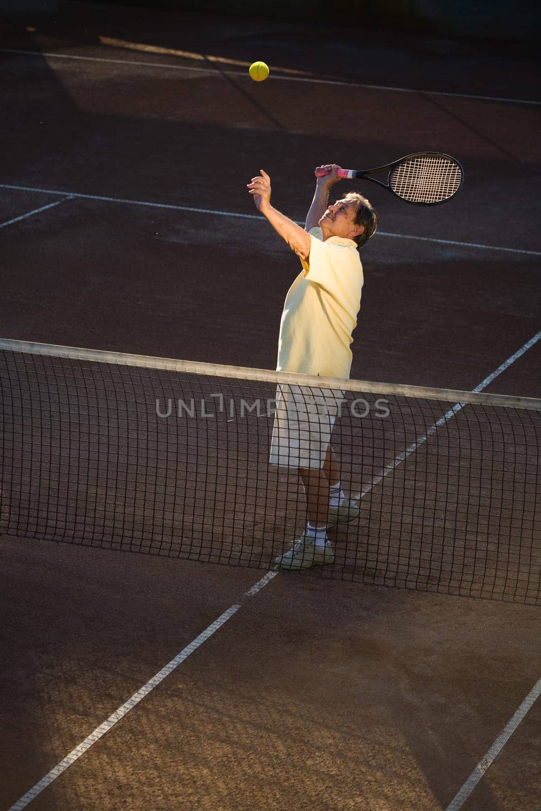 Senior man playing tennis