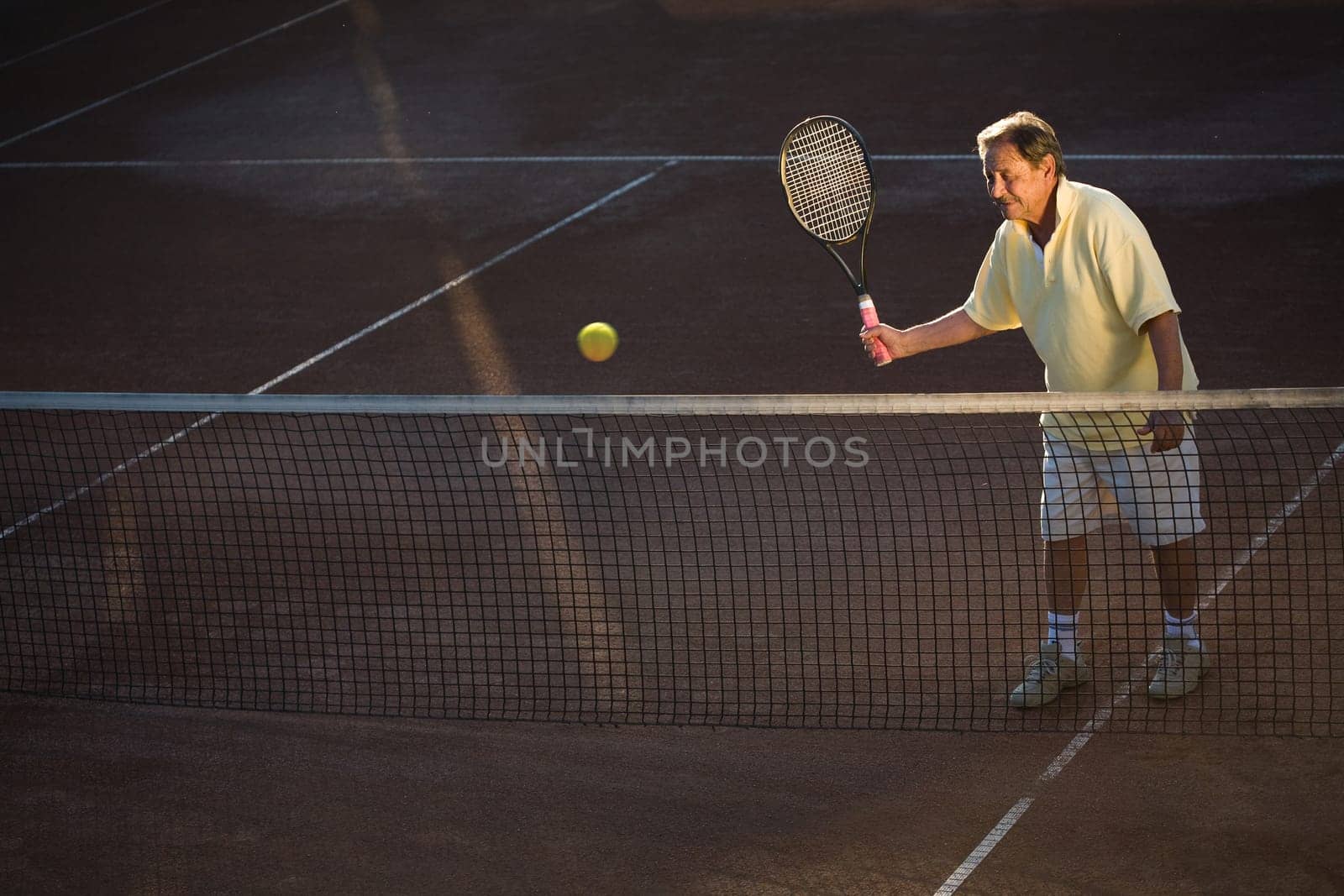 Senior man playing tennis