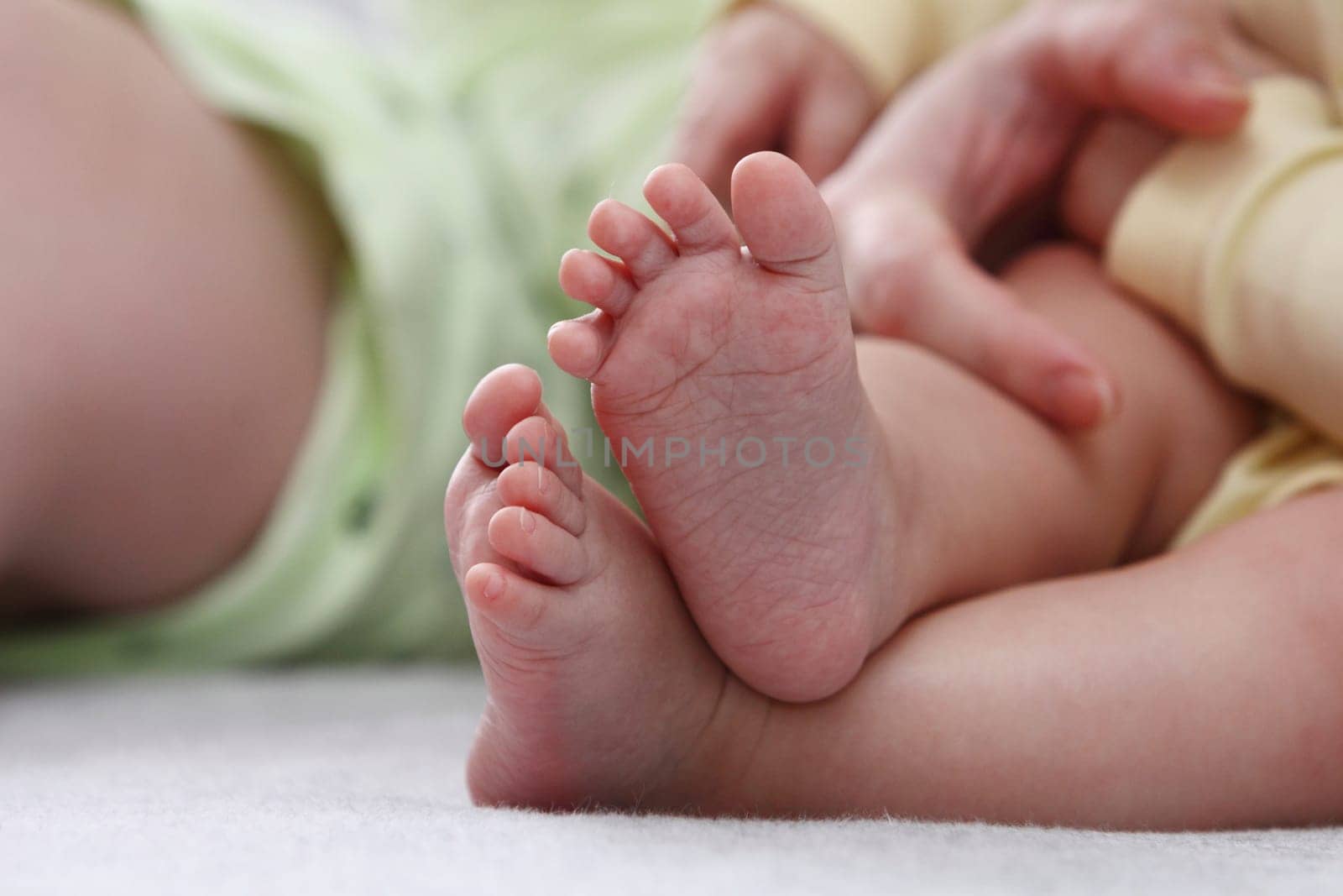 Mother holding her childs feet