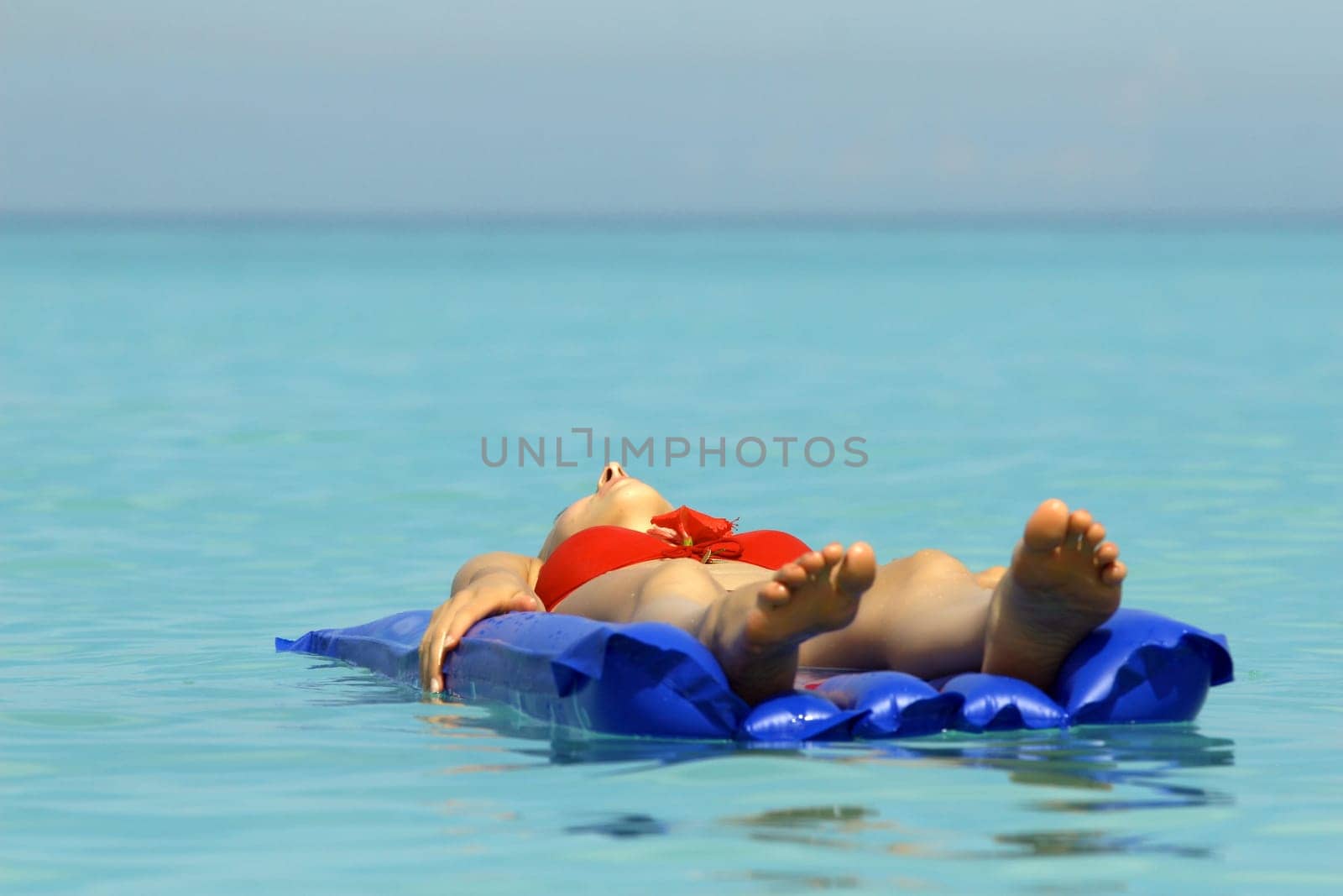 Woman floats on the air mattress