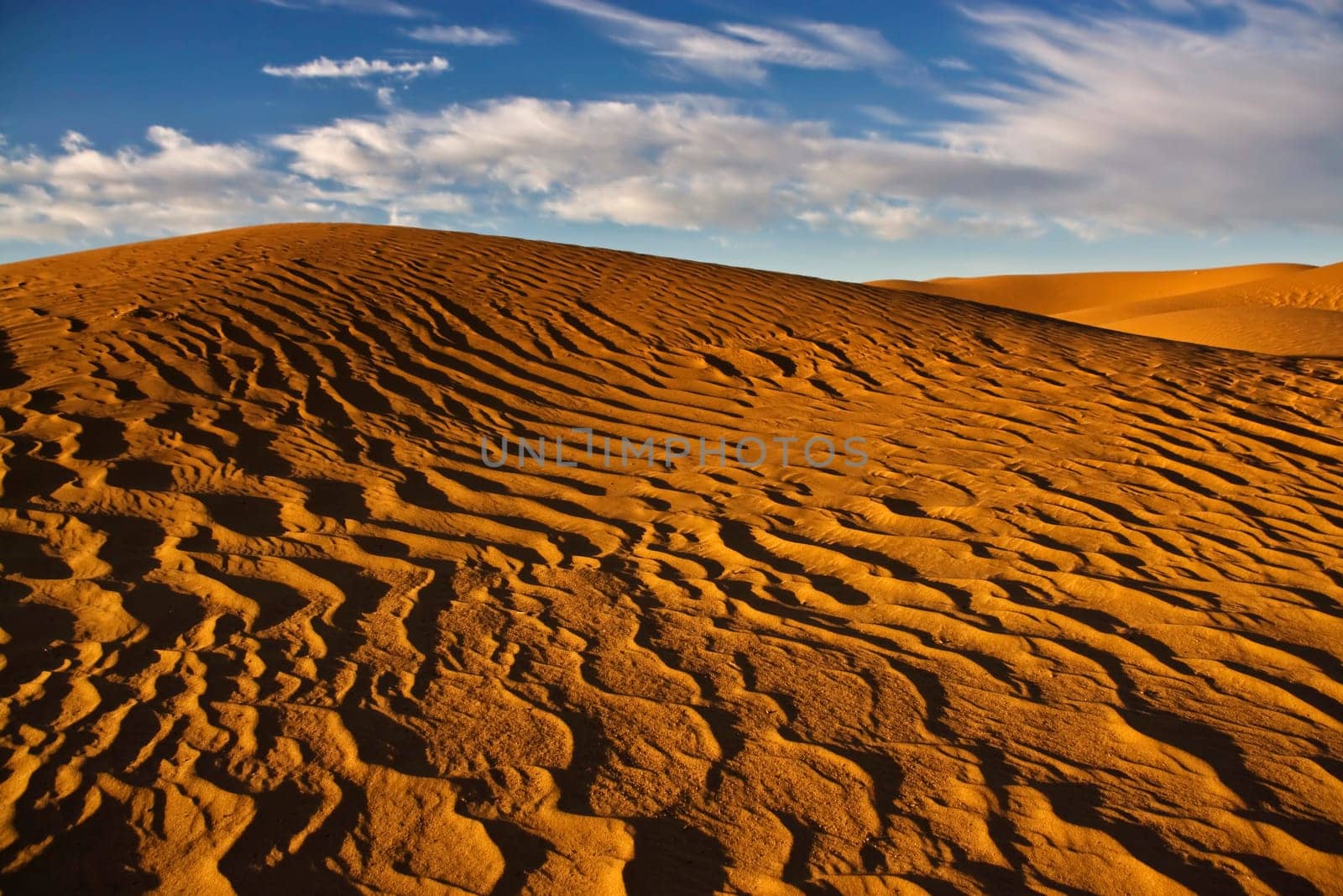 sand dunes in desert with blue sky