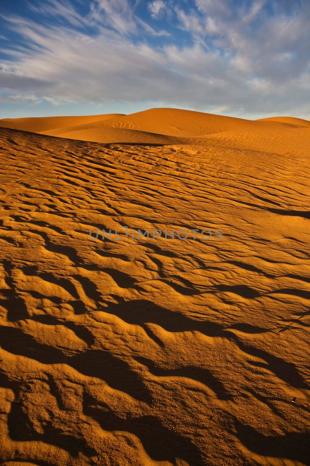 sand dunes in desert with blue sky