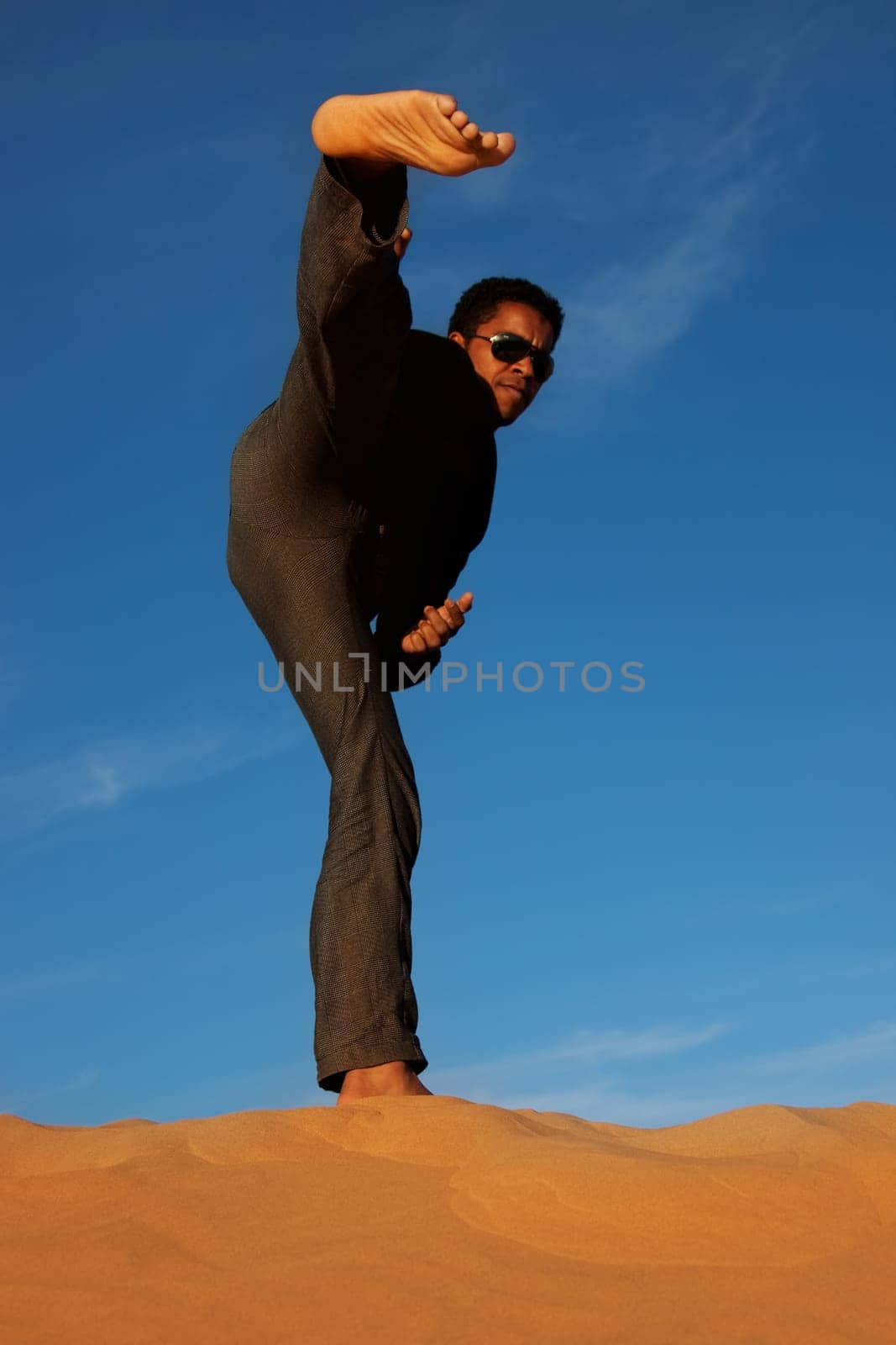 man practicing karate in the desert