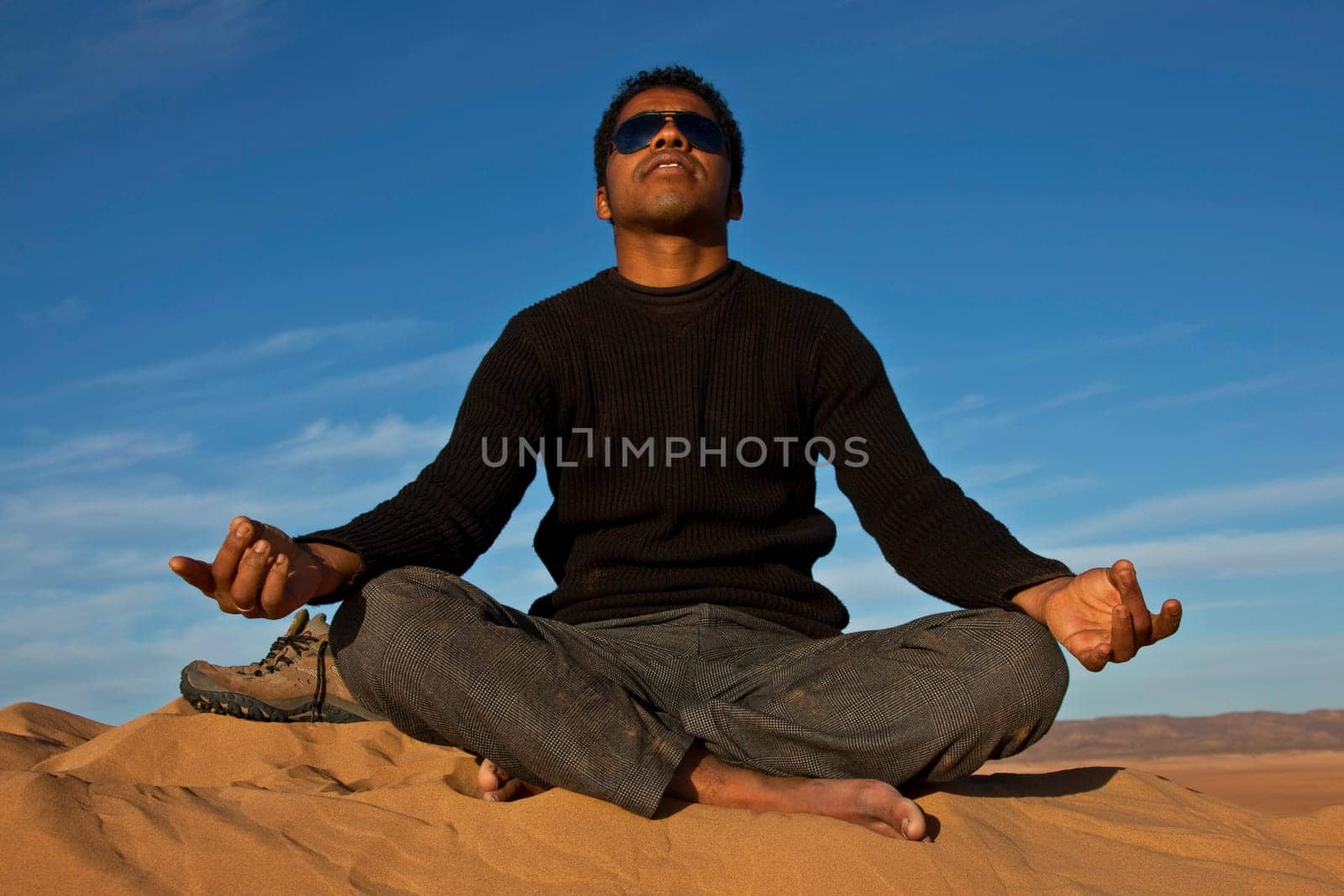 attractive young man meditating
