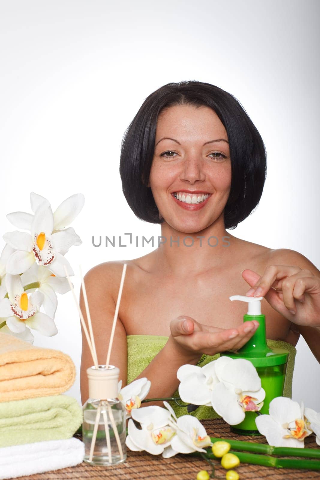 Cheerful woman wants to apply cream to hands