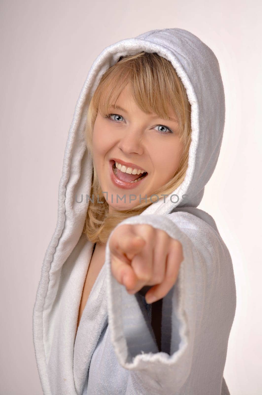 woman in bathrobe pointing at you