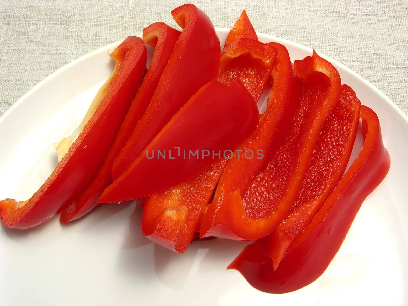 Red bell pepper cut into strips on plate