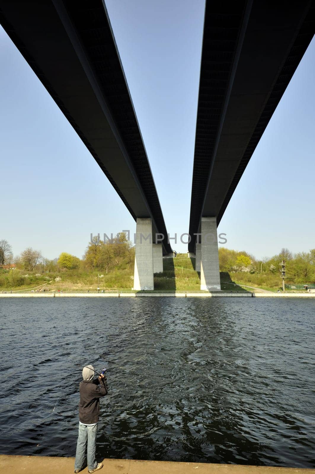 Boy fishing under the Holtenauer High Bridge in Kiel