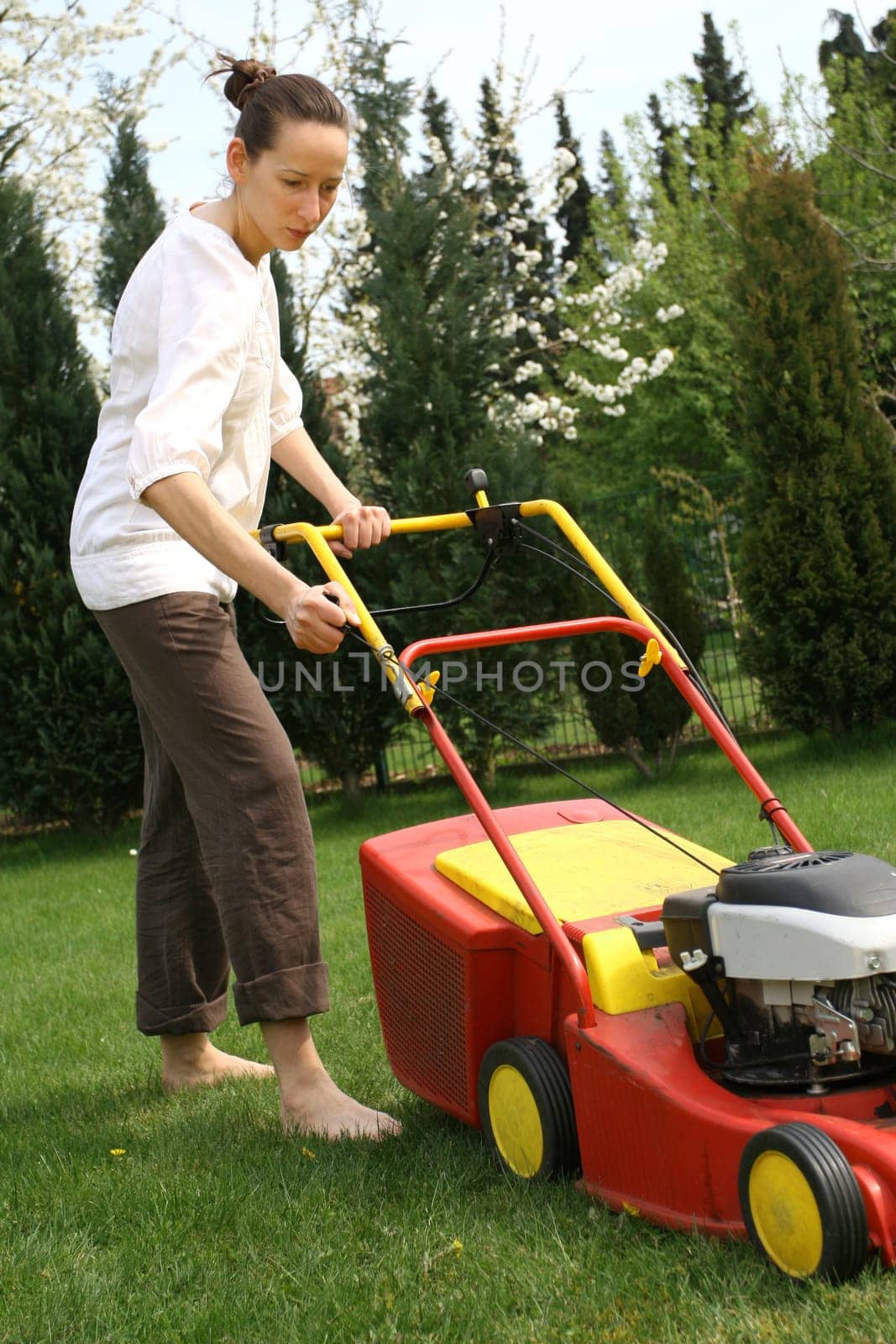Woman mows lawn