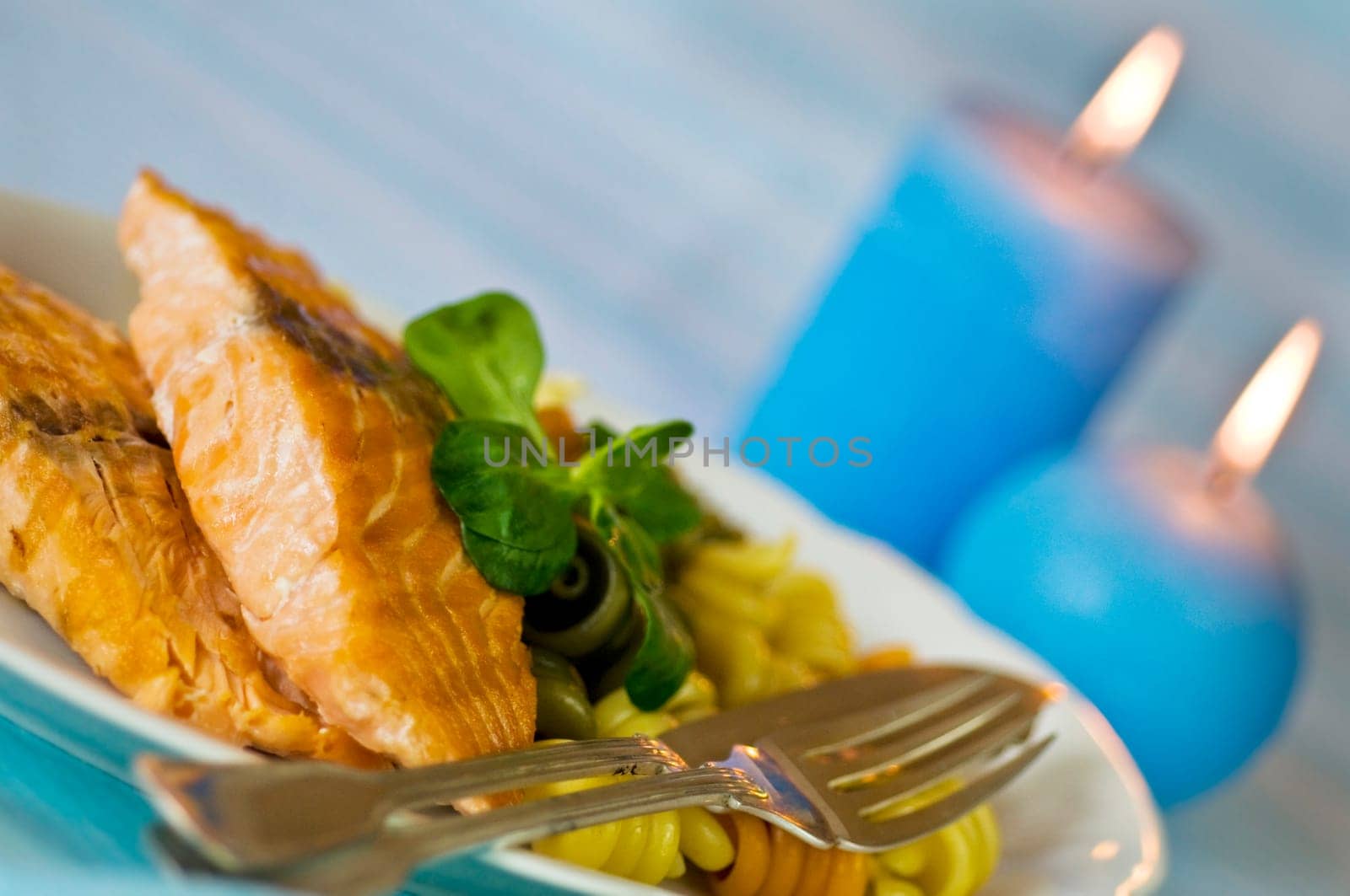 Salmon fillet with noodles served on plate