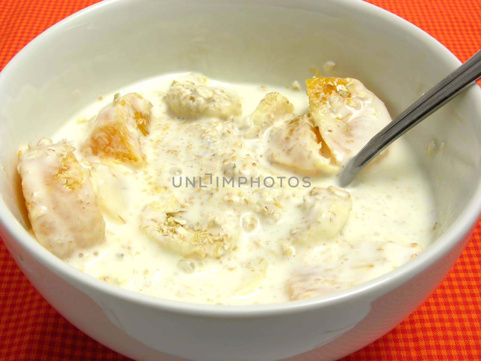 Yoghurt with finely chopped banana,tangerine and oatmeal