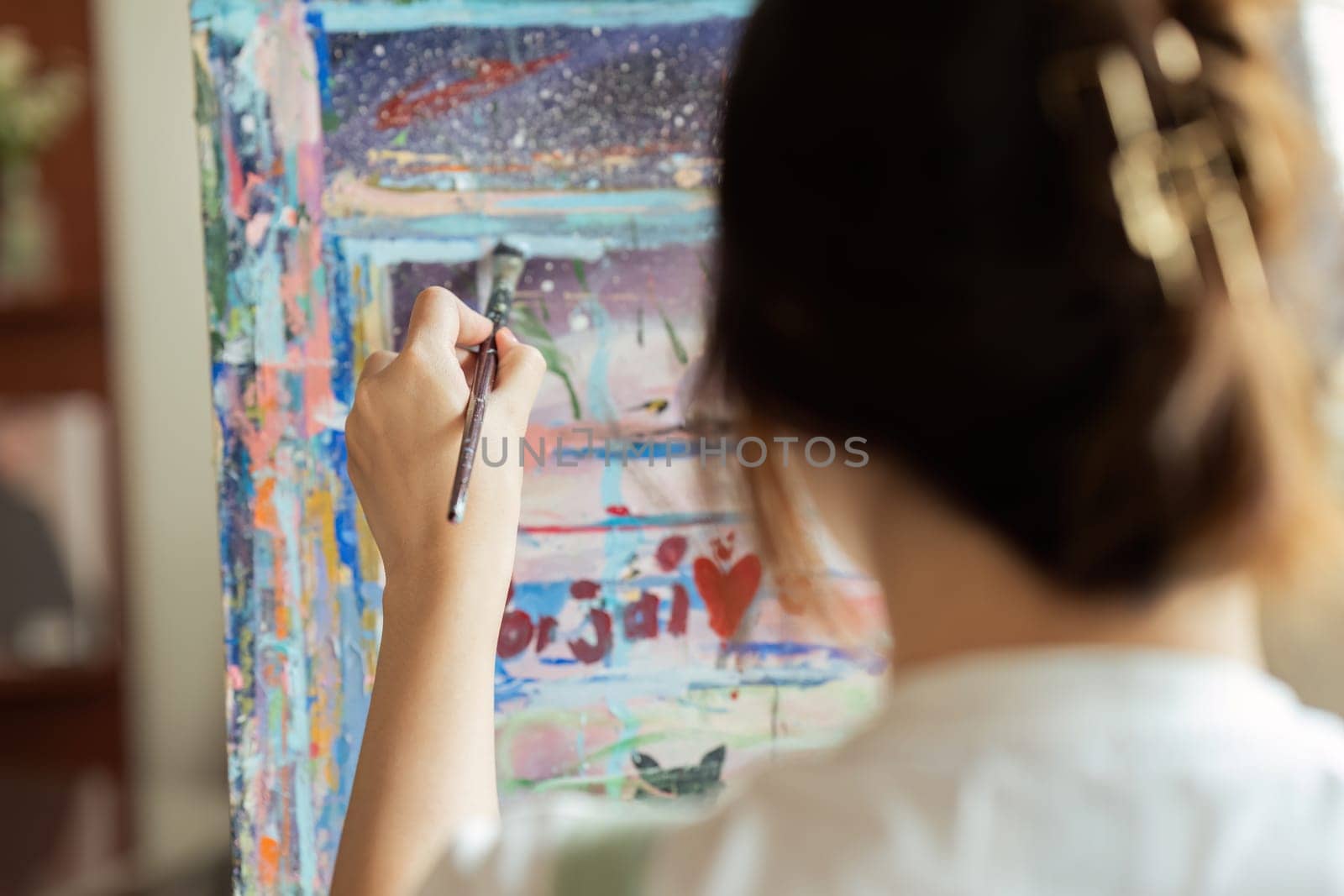 Close up Asian Woman painting on canvas during special skills class. Artist concept by itchaznong