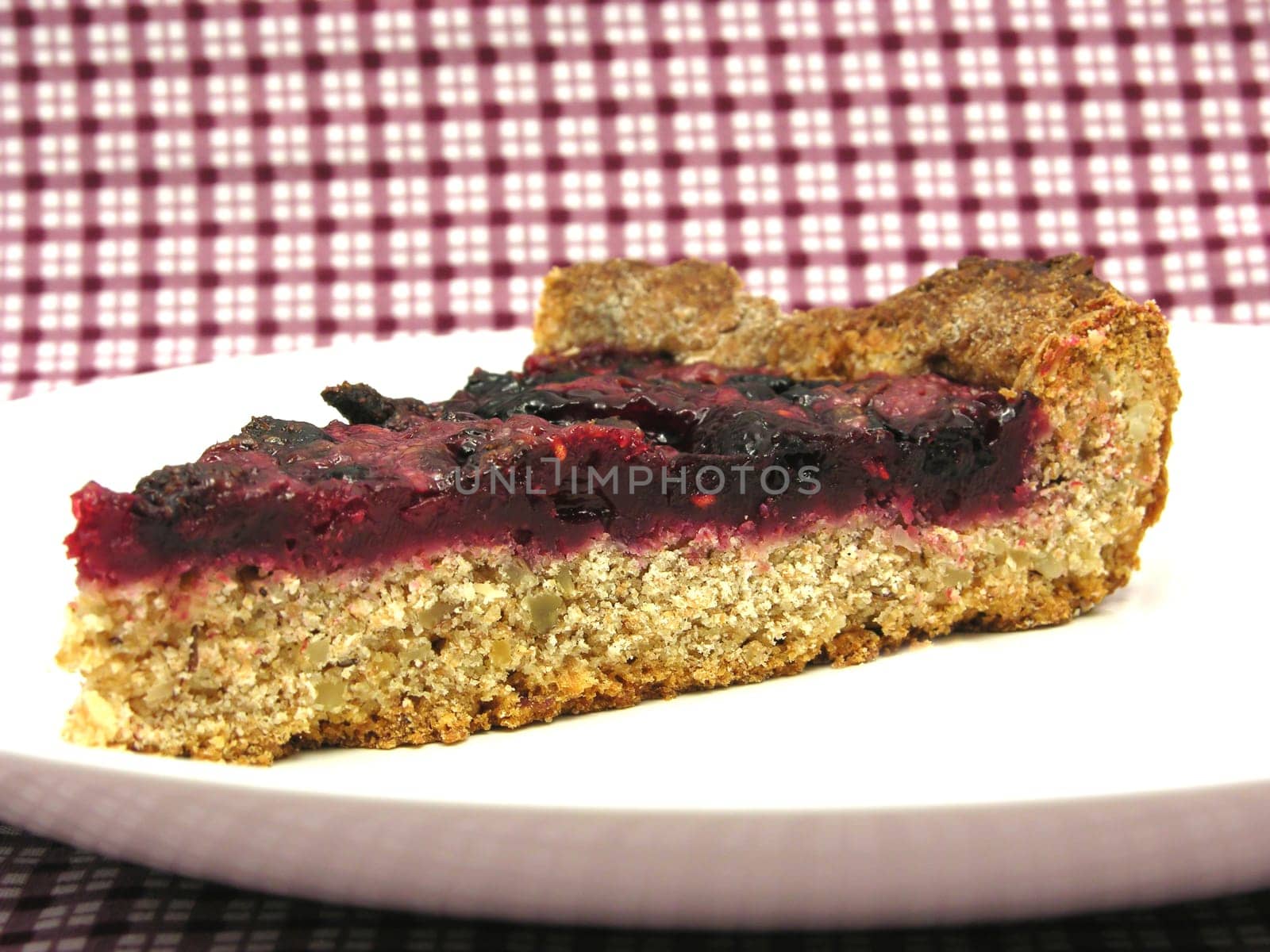 A piece of berry cake on a white plate
