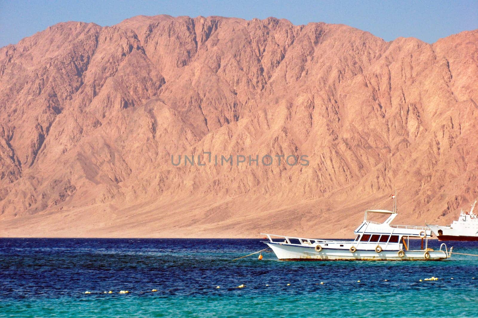 Egypt Nuweiba - beach with mountains and boats at Reds sea